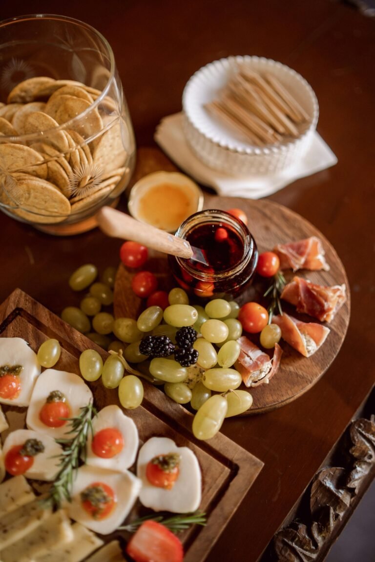 Close-up of a charcuterie board featuring cheeses, meats, fruits, and crackers, perfect for events and gatherings.